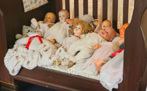 Dolls in a cot
