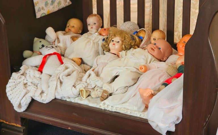 Dolls in a cot
